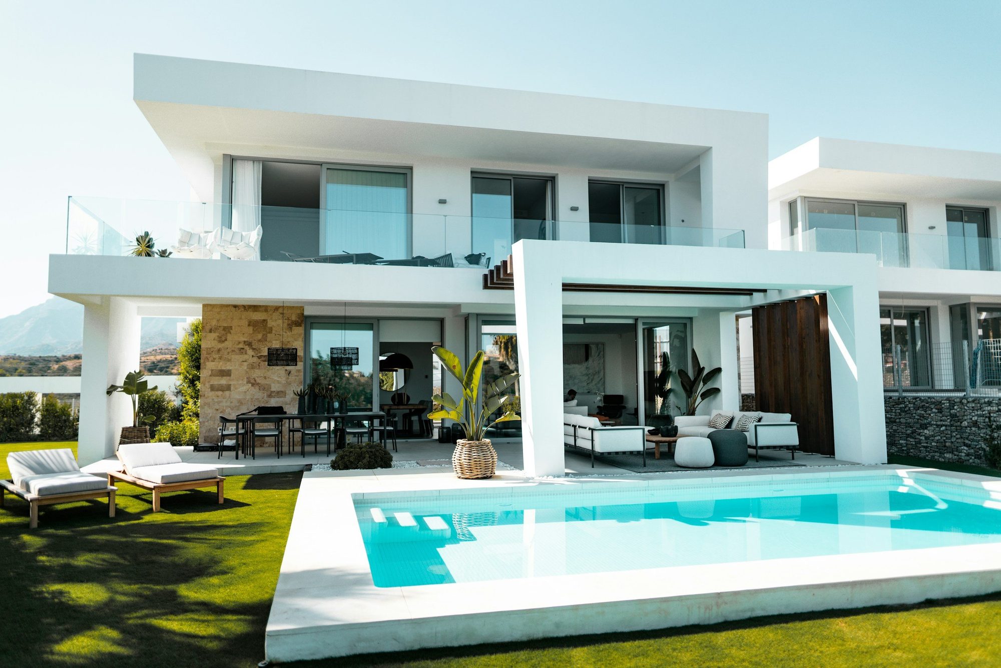 White two-storey villa with outdoor pool